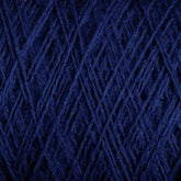 Close-up image of dark blue JaggerSpun Maine Line 2/20 Yarn in a large cone, tightly wound in a crisscross pattern, showcasing the textures of the fibers. The worsted spun yarn from Jagger Brothers, Inc. appears soft and fuzzy, with a rich and deep navy color.