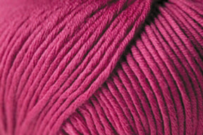 Close-up image of a ball of Jo Sharp Soho Summer DK Cotton by Kingfisher Yarn & Fibre in a rich magenta color. The yarn appears thick with individual strands tightly wound together, showcasing its texture and smoothness. The image highlights the lightweight cotton's detail and vibrant hue, perfect for summer knitting projects.