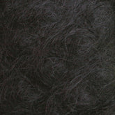 Close-up image of dark, tangled Victorian Brushed Mohair Yarn from Caledonian Dye Works. The strands are densely packed with varying shades of dark brown and some hints of grey. The texture appears coarse and thick, reminiscent of natural fiber, creating an intricate, interwoven pattern throughout the image.
