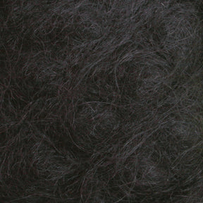 Close-up image of dark, tangled Victorian Brushed Mohair Yarn from Caledonian Dye Works. The strands are densely packed with varying shades of dark brown and some hints of grey. The texture appears coarse and thick, reminiscent of natural fiber, creating an intricate, interwoven pattern throughout the image.
