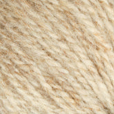 Close-up image of a ball of Bartlettyarns Maine Wool Yarn. The texture is visibly soft and finely woven, featuring heathered colors with hints of lighter and darker beige strands. This worsted weight yarn appears natural, slightly fuzzy, and reminiscent of the quality that Bartlettyarns is known for.