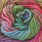 Close-up image of a skein of the Noro Silk Garden yarn from Knitting Fever / Euro Yarns in a swirl pattern, showcasing vibrant self-striping colors including pink, green, blue, and purple. This silk/wool blend yarn features a soft and slightly fuzzy texture with visible fibers throughout the strands.