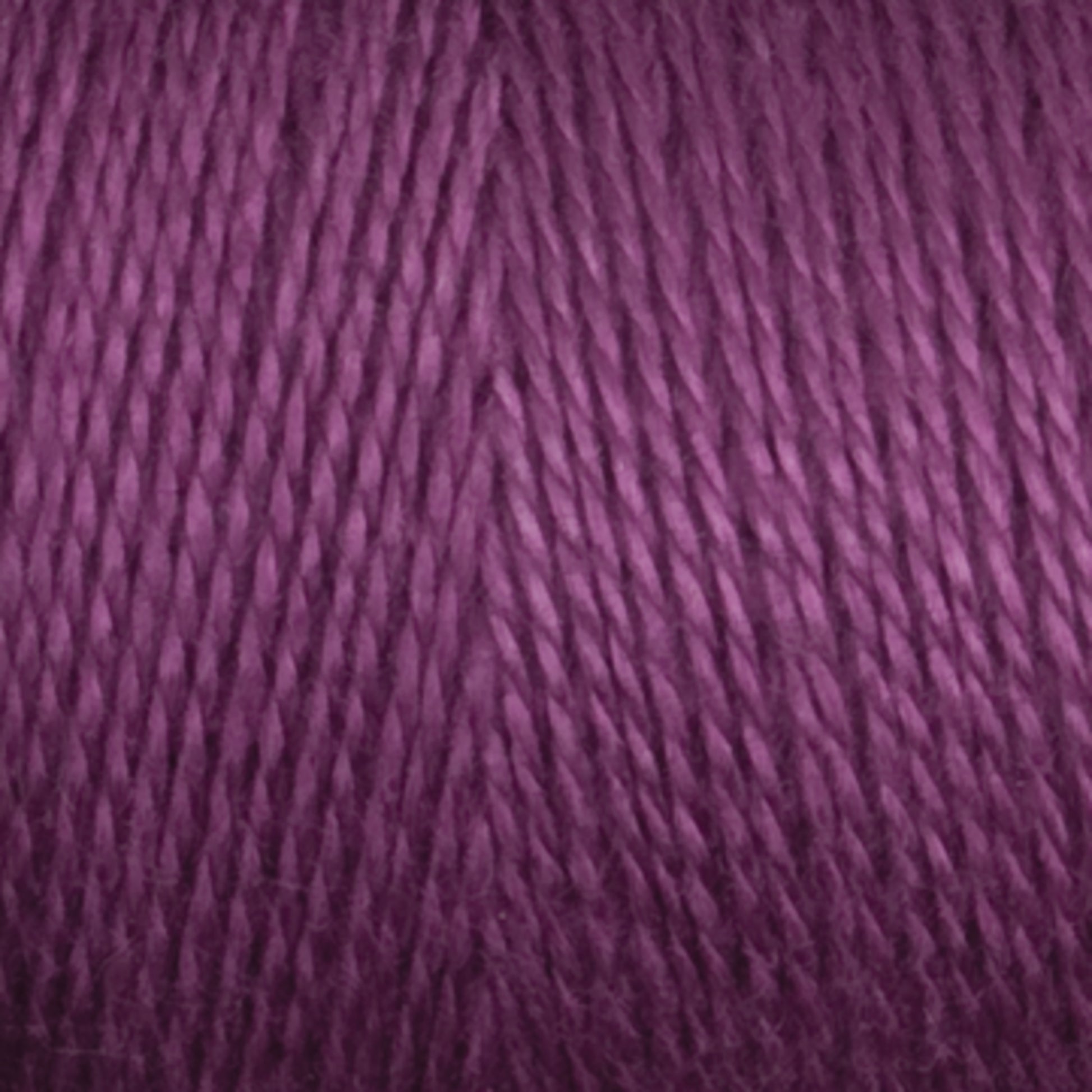 Close-up of a skein of Maurice Brassard's 8/2 Bamboo Yarn | Mini-cone. The fibers are tightly wound and have a smooth texture, showcasing various shades of purple from light to dark. This environmentally friendly yarn appears soft and perfect for knitters' crochet or knitting projects.