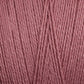 Close-up view of Maurice Brassard's 8/2 Bamboo Yarn | Tube in a soft, muted pink color. The strands are tightly wound together, showcasing the yarn's fibrous detail and slightly glossy sheen. This eco-friendly bamboo yarn offers antibacterial properties while maintaining its delicate charm.