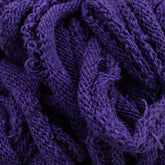 Close-up of rumpled, Harrisville Potholder Loops in purple from the Traditional Size Mini Pack by Friendly Loom. The loops are tightly woven together, similar to a traditional loom, creating a rich texture with intricate patterns and various folds and creases.