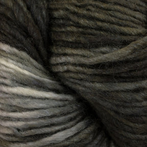 A close-up image of a skein of Malabrigo Silky Merino yarn in shades of dark green, gray, and white. The individual fibers and texture of the merino yarn from Malabrigo Yarn are clearly visible, showcasing a soft, wooly appearance with a blend of colors.