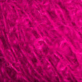 Behold a detailed close-up view of the bright pink fuzzy yarn from Caledonian Dye Works' Victorian Bouclé Mohair Yarn. The texture reveals individual fibers and loops, giving it a soft and fluffy look. Its vibrant color and intricate texture underscore the material's perfect fit for cozy, handmade crafts and garments.