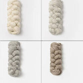 Four bundles of Blue Sky Fibers Metalico sport weight yarn are displayed on a white background, each in a separate quadrant. The colors are: top left - off-white, top right - light grey, bottom left - medium grey, and bottom right - taupe. All bundles of Blue Sky Fibers' neatly wound alpaca yarn are arranged in a braid pattern.