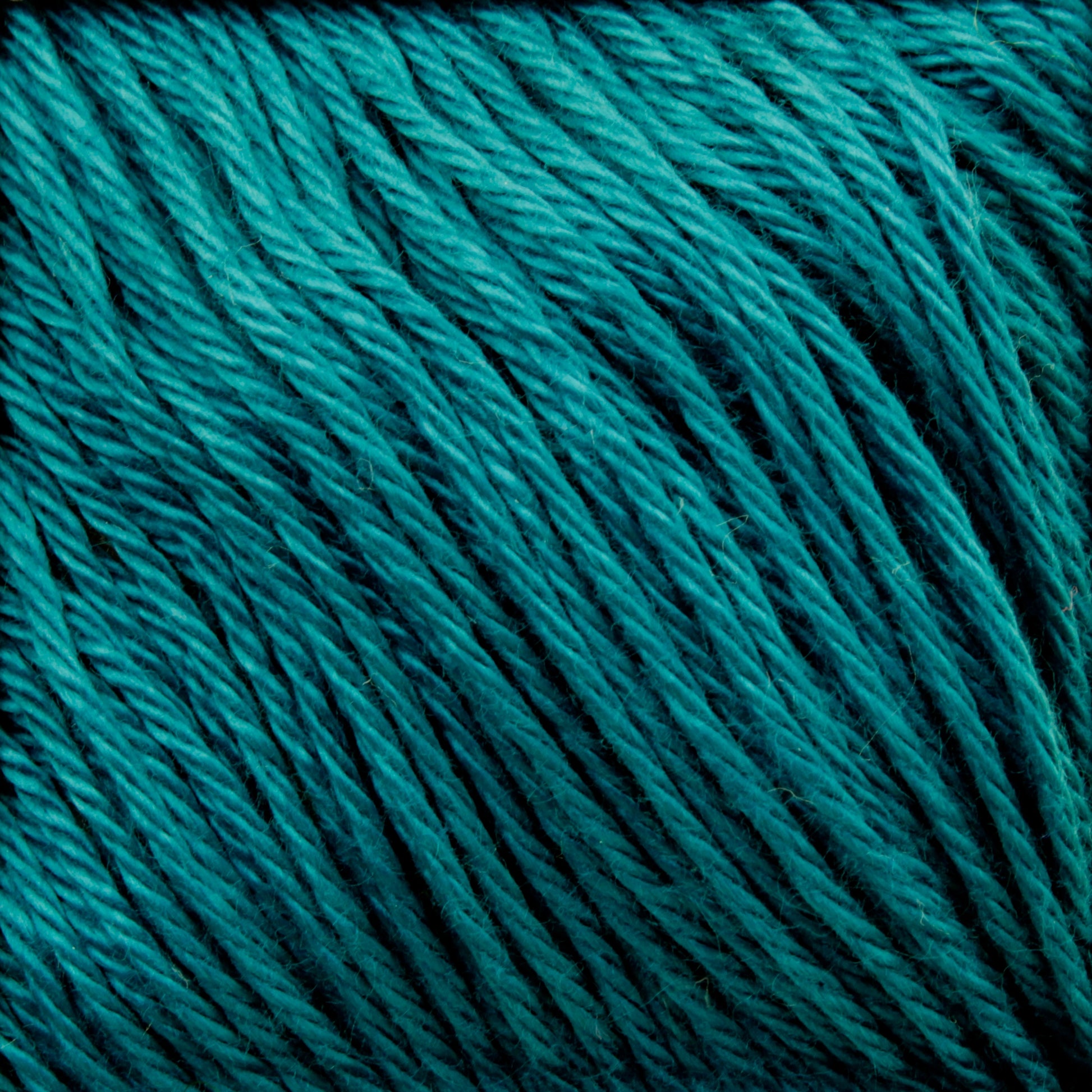 Close-up of tightly wound Cascade Ultra Pima Cotton Yarn in turquoise, showcasing the soft hand and thick strands. The yarn is neatly coiled, creating a striped pattern with varying shades of blue and green from luxurious Peruvian Pima Cotton by Cascade Yarns, giving it a rich, vibrant appearance.