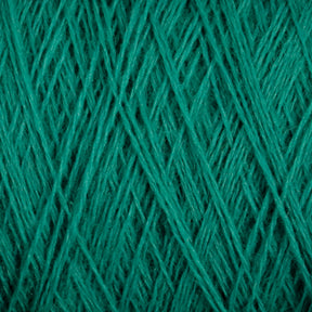 Close-up image of green JaggerSpun Maine Line 3/8 Yarn | Mini-cone wound tightly in overlapping, crisscrossing patterns, creating a textured, woven appearance. The yarn fibers are clearly visible, highlighting the detailed structure and color of the worsted spun material from Jagger Brothers, Inc.