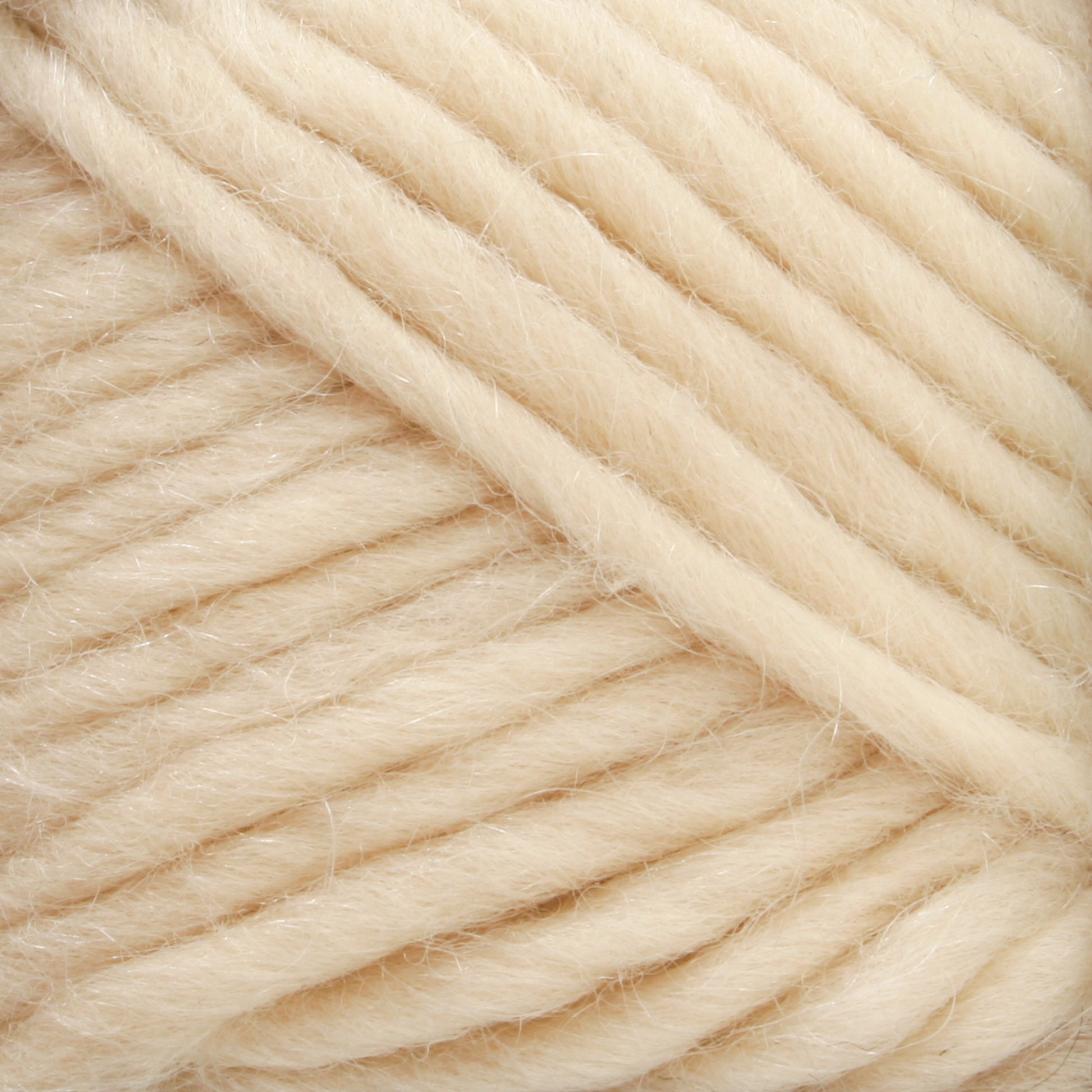 Close-up of Lamb's Pride Worsted Yarn by Brown Sheep, showcasing its soft, thick, cream-colored strands wound into a ball. The yarn features a fuzzy texture with a slight sheen, making it perfect for felting projects. The neatly aligned strands lie in parallel lines.