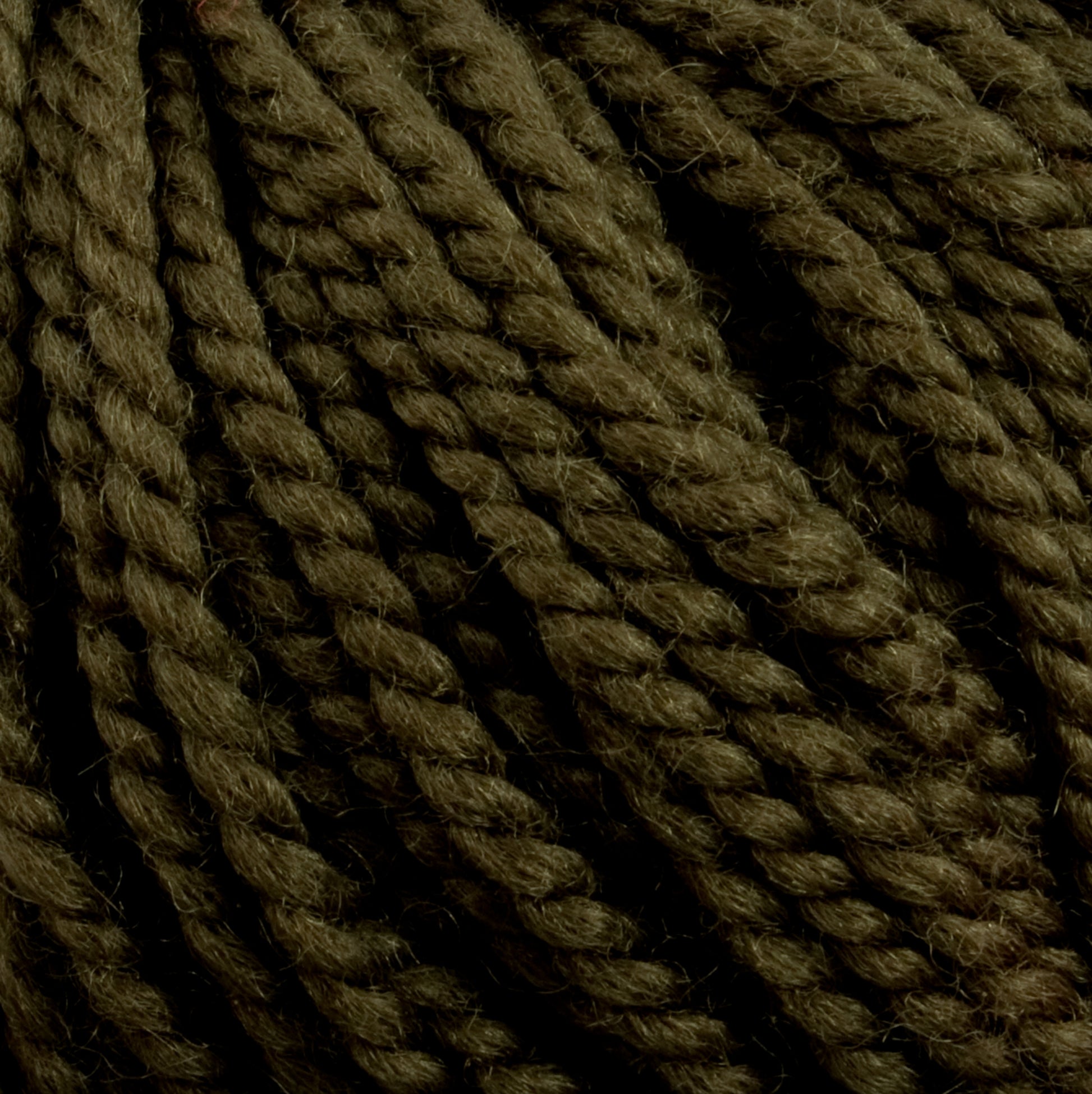 Close-up image of Norumbega yarn by Caledonian Dye Works, showcasing its tightly wound, thick, olive green Aran weight fibers and twisted strands, made from 100% U.S. wool.