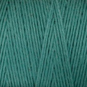 Close-up texture of Maurice Brassard Medium Cotton 16/8 Mop Yarn in a teal color. The fibers are tightly wound, creating a uniform pattern of parallel lines. The yarn appears soft with a slight sheen, making it ideal for knitting or weaving sturdy cotton projects.