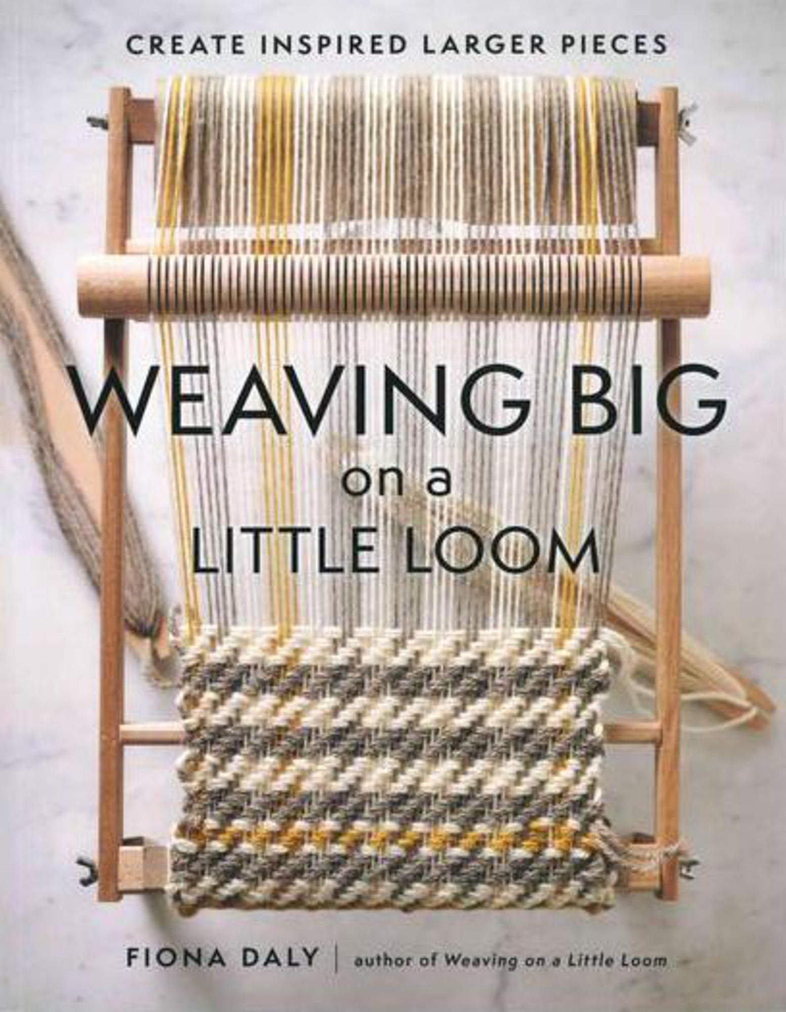 Cover of the book "Weaving BIG on a Little Loom" by Fiona Daly, published by Ingram Content. The image shows a loom with woven fabric and threads stretched on it, set against a light background. Perfect for intermediate beginners, the book's subtitle reads "Create Inspired Larger Pieces." Fiona Daly is the author.