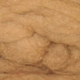 A close-up image shows a section of light brown wool roving. The texture is soft and fibrous, with visible strands compacted together. This Harrisville Designs Dyed & Carded Wool Fiber has fibers that display a natural, uneven appearance, indicating an organic material ideal for felting wool projects.