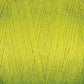 Close-up of a spool of bright yellow-green 8/2 Bamboo Yarn by Maurice Brassard. The tightly wound fibers display a smooth, shiny texture, highlighting the thread’s uniformity and vibrant color. Made from environmentally friendly materials, this antibacterial thread is both durable and sustainable.