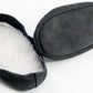 A pair of Bryson Distributing, Inc.'s Suede Leather and Fleece Soles slippers, one laying face up showcasing its fuzzy white fleece lining, and the other laying face down displaying its smooth suede sole.