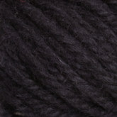 Close-up image of a ball of Halcyon Yarn Classic Rug Wool in dark charcoal gray. The texture, including individual strands and slight fibers, is clearly visible, highlighting its soft and slightly fuzzy appearance. Perfect for weavers seeking high-quality material from Caledonian Dye Works for their hand-dye projects.