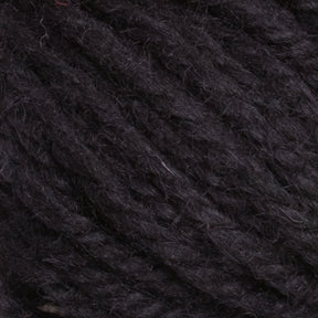 Close-up image of a ball of Halcyon Yarn Classic Rug Wool in dark charcoal gray. The texture, including individual strands and slight fibers, is clearly visible, highlighting its soft and slightly fuzzy appearance. Perfect for weavers seeking high-quality material from Caledonian Dye Works for their hand-dye projects.