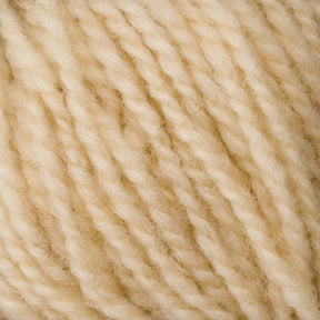 A close-up image of Bartlettyarns' Bartletts Maine Wool - Sport reveals a bundle of cream-colored, twisted sport weight yarn strands. The wool appears soft and woolly with a slightly fuzzy texture. The tightly wound strands showcase the intricate detail of the fibers.