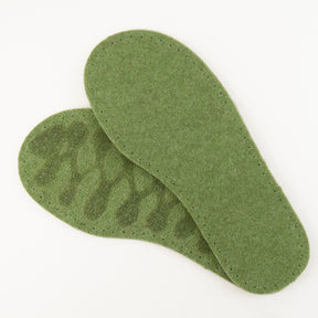 Two green insoles from Joe's Toes' Adult's Thick Felt Slipper Soles w/Latex Grip collection are displayed, one overlapping the other. The insole on the bottom showcases its textured surface with an indented wavy pattern, while the top insole displays a smooth surface. Made from eco-friendly wool, these insoles are perfect for your next felt slipper sole project. They rest on a plain white background.