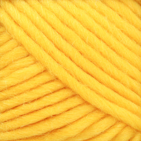 Close-up image of thick, chunky yellow Lamb's Pride Bulky Yarn from Brown Sheep. The yarn is tightly wound, with individual fibers visible, creating a soft and fluffy texture. The vibrant yellow color dominates the image, offering a warm and inviting appearance that is perfect for knitters and crocheters working on Icelandic sweaters.