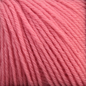 Close-up of a bundle of Baby Blatt by Anny Blatt from Essentially Felt Studio & Fine Yarn. The soft, pink strands are neatly wound and have a slightly fuzzy texture, appearing thick and ideal for knitting or crocheting warm garments or accessories. This vibrant, evenly dyed pink yarn is also machine washable for added convenience.