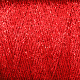 Close-up of Astra Glow Metallic yarn in red, wound tightly around a large cone. The shiny, reflective fibers create a zigzag pattern, showcasing intricate detail and texture. A great weaving tip from Huntingdon Yarn Mill, Inc. is to occasionally hand wash to maintain its vibrant color and sparkling surface, making it visually striking and eye-catching.