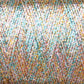 A close-up view of Astra Glow Metallic | Mini-cone yarn by Huntingdon Yarn Mill, Inc., showcasing a mix of pastel shades including pink, blue, yellow, and white. The intricate thread pattern creates a subtle shimmer and texture, highlighting the softness and detail of the woven fibers. Perfect for hand and machine knitters, this delicate blend deserves gentle hand wash care.