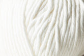 A close-up image of the Jo Sharp Desert Garden Aran Cotton from Kingfisher Yarn & Fibre highlights the soft, white yarn, revealing the texture and twists of its fibers. The thick, fluffy yarn suggests it is an Aran weight cotton suitable for knitting or crocheting warm, cozy items. The background is entirely filled with the yarn, emphasizing its texture and knitting performance.