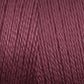 A close-up image of Maurice Brassard's 8/2 Bamboo Yarn in burgundy. The texture appears smooth, with uniformly twisted strands that create a consistent and rich hue. The photo emphasizes the yarn's details, showcasing its silky and slightly shiny appearance—ideal for environmentally conscious knitters.