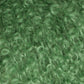 Close-up view of Victorian Bouclé Mohair Yarn from Caledonian Dye Works, showcasing a green curly and fluffy texture that resembles synthetic artificial hair or fur. The tightly wound curls and vibrant color give the material a dense and playful appearance, reminiscent of Halcyon's Signature Victorian Collection.