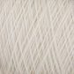 A close-up view of a bundle of cream-colored JaggerSpun Maine Line 3/8 Yarns from Jagger Brothers, Inc., showcasing the detailed texture and intricately neat fibers wound together. The strands form a soft and uniform pattern of worsted spun yarns on the large cone.