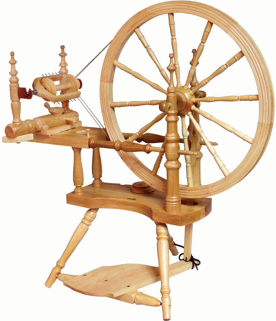 The Kromski Polonaise Spinning Wheel by Kromski North America is a traditional wooden spinning wheel, featuring a large wheel on the right, a smaller wheel on the left, and a foot pedal at the base. Its intricate construction includes multiple spindles and supports, all crafted from light-colored European alder and birch wood.