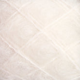 Close-up view of soft, white fluffy fibers tightly packed in a grid-like pattern, resembling luxurious Victorian Brushed Mohair Yarn from Caledonian Dye Works. The texture appears delicate and airy, with a subtle shine.