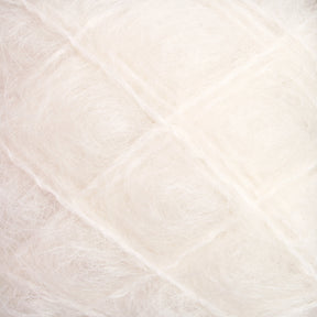 Close-up view of soft, white fluffy fibers tightly packed in a grid-like pattern, resembling luxurious Victorian Brushed Mohair Yarn from Caledonian Dye Works. The texture appears delicate and airy, with a subtle shine.