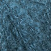 Close-up view of tight, curly, blue fibers with a soft, fuzzy texture. The dense arrangement of curls creates a rich, intricate pattern reminiscent of Caledonian Dye Works’ Victorian Bouclé Mohair Yarn from their Signature Collection.