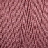 A close-up view of Maurice Brassard's 16/2 Bamboo Yarn strands arranged neatly in parallel. The texture of the yarn is visible, showcasing the intertwined threads and a soft, smooth surface. This antibacterial, sustainable yarn is colored in a muted, dusty rose pink.