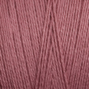 A close-up view of Maurice Brassard's 16/2 Bamboo Yarn strands arranged neatly in parallel. The texture of the yarn is visible, showcasing the intertwined threads and a soft, smooth surface. This antibacterial, sustainable yarn is colored in a muted, dusty rose pink.