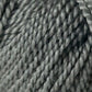 Close-up of the Jo Sharp Alpaca Kid Lustre yarn by Kingfisher Yarn & Fibre. The yarn's texture and individual strands are prominently visible, highlighting its thickness and twist pattern. This Merino blend is a muted, neutral grey, ideal for knitting or crocheting projects.