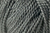 Close-up of the Jo Sharp Alpaca Kid Lustre yarn by Kingfisher Yarn & Fibre. The yarn's texture and individual strands are prominently visible, highlighting its thickness and twist pattern. This Merino blend is a muted, neutral grey, ideal for knitting or crocheting projects.