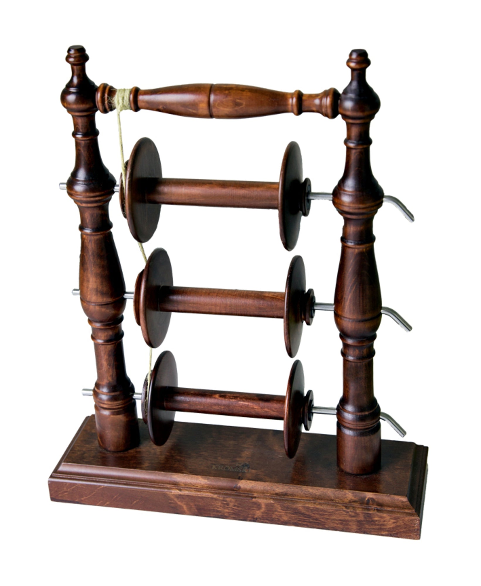 The Kromski Lazy Kate Arch by Kromski North America is a wooden thread stand featuring three horizontal spindles for holding spools of thread, elegantly mounted between two ornate, turned-wood posts. Its rectangular base supports an additional decorative wooden handle that connects the top ends of the posts. It’s perfect for ply yarn enthusiasts seeking elegance in their setup.