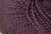 Close-up image of a dark purple, soft, and thick Jo Sharp Alpaca Kid Lustre yarn by Kingfisher Yarn & Fibre showing detailed texture and individual strands twisted together.