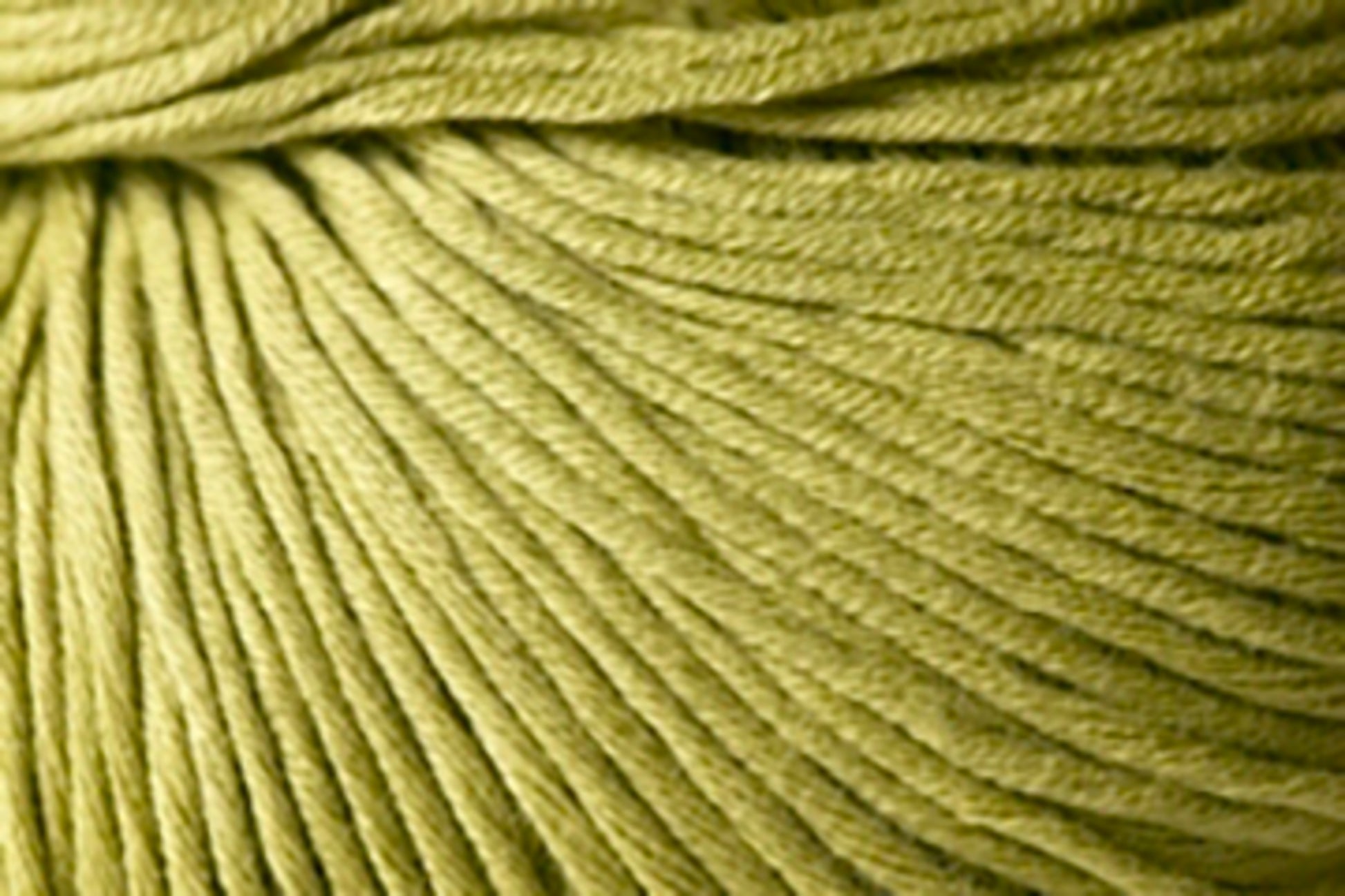 A close-up image of Kingfisher Yarn & Fibre's Jo Sharp Soho Summer DK Cotton, showcasing the texture of its twisted strands. The yarn appears soft and of medium thickness, with a slight sheen on the surface. The light lime green shade is perfect for summer yarn projects.