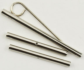 The image shows a set of Knitter's Pride Cord Connectors by Accessories Unlimited, including several cord connectors and three different-sized cords lying on a white surface, reminiscent of the precision and craftsmanship found in Tunisian crochet hook sets.