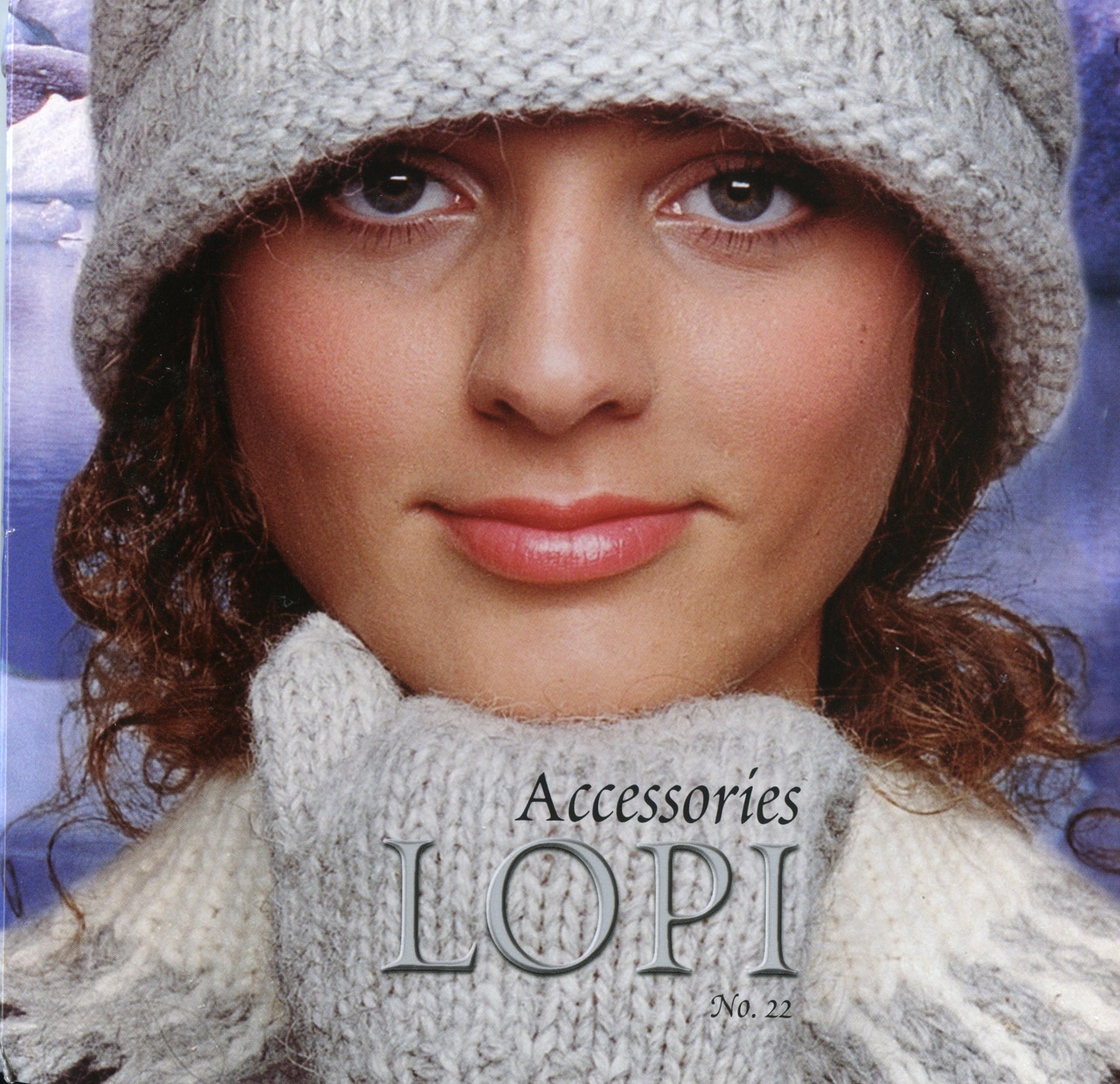 A woman wearing a knitted gray hat and matching scarf is posing in front of a winter-themed background, showcasing accessories made with bulky weight yarn. The text on the image reads "Berroco, Inc. Lopi #22, Accessories".