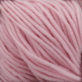 Close-up image of Plymouth Yarn Co.'s Plymouth Select Worsted Merino Superwash in soft pastel pink. The thick, closely wound strands highlight a smooth and fluffy texture with excellent stitch definition. The delicate and gentle appearance of the yarn makes it perfect for knitting or crocheting cozy garments.