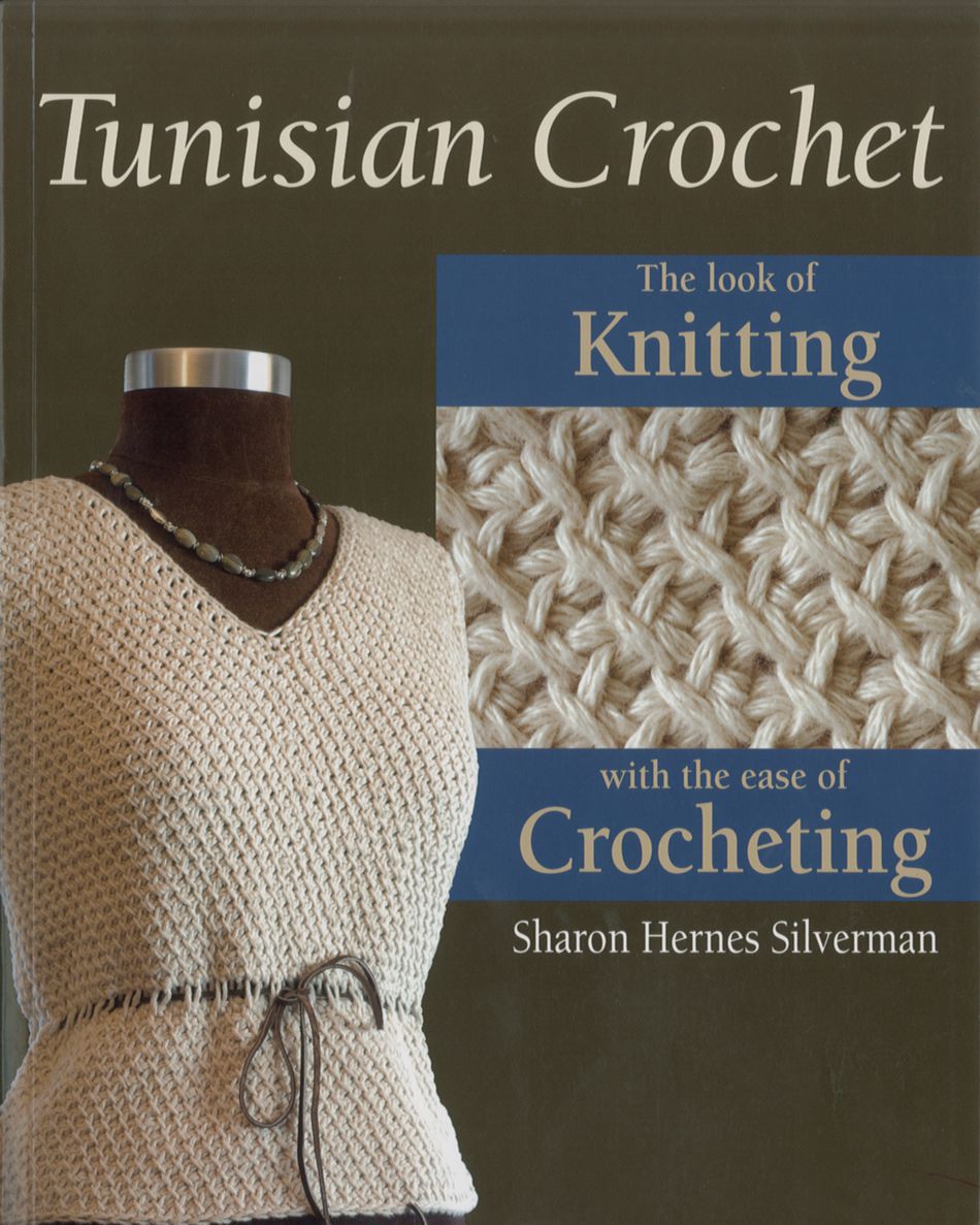 The book "Tunisian Crochet" from National Book Network features a cover with a crocheted sweater displayed on a mannequin, highlighting its high fashion appeal. On the right side, you can see a close-up of the Afghan Stitch pattern. The text reads, "The look of Knitting with the ease of Crocheting.