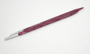 A single Dreamz Interchangeable Knitting Needle Tip from Accessories Unlimited, featuring a maroon finish and a metallic tip, is positioned diagonally on a white background. The needle, perfect for knitting hats, is pointed on one end with the size "US 9 - 5.50 mm" inscribed near the tip.