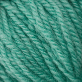 Close-up of Halcyon Deco Rug Wool strands twisted together in vibrant turquoise, showcasing a soft, fibrous texture. This versatile yarn from Caledonian Dye Works is 100% wool and ideal for crafting a luxurious Deco rug.